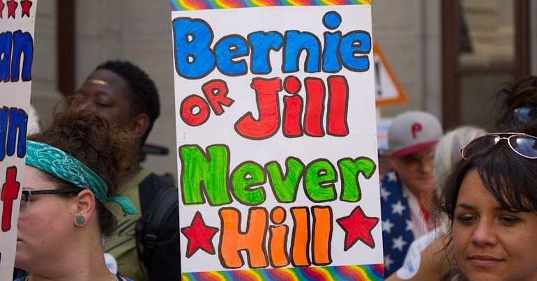 Leftists hold up sign for Bernie Sanders and Jill Stein