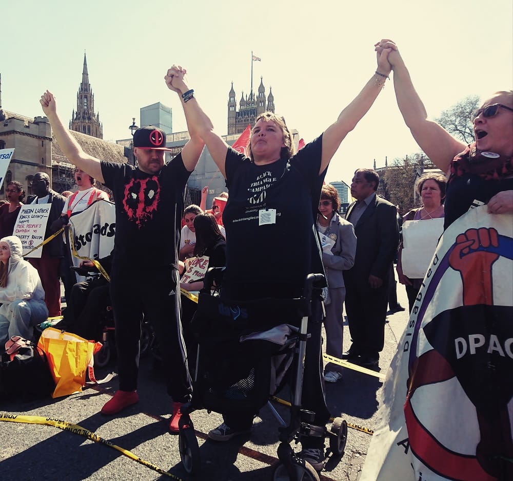 DPAC activists linked arms in solidarity