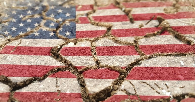 US flag on ground with cracks in it