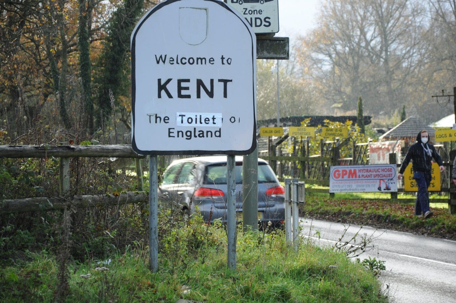 A road sign which reads 'Welcome to Kent: The toilet of England'