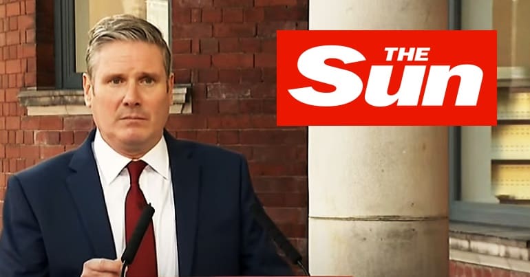 Keir Starmer with the Sun logo