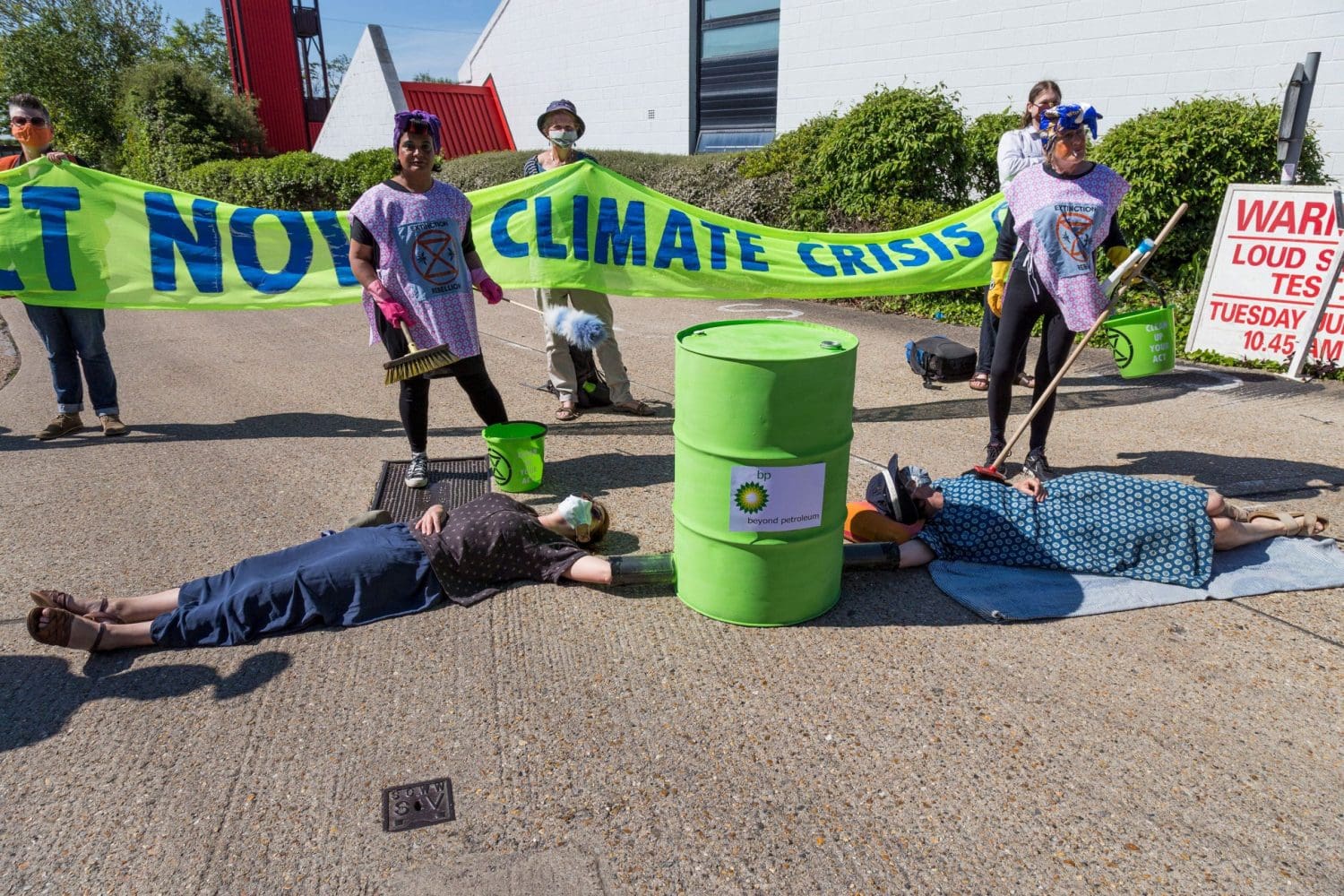 Climate protestors locked on to a barrel