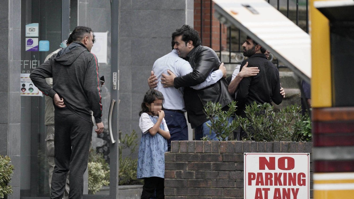 Refugee families outside the hotel