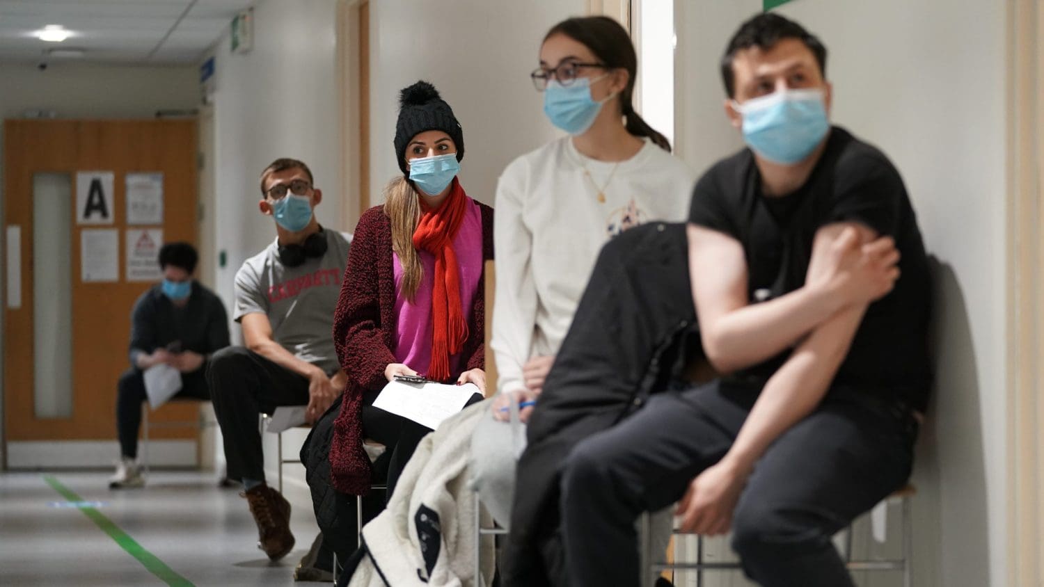 A queue of people waiting to be vaccinated