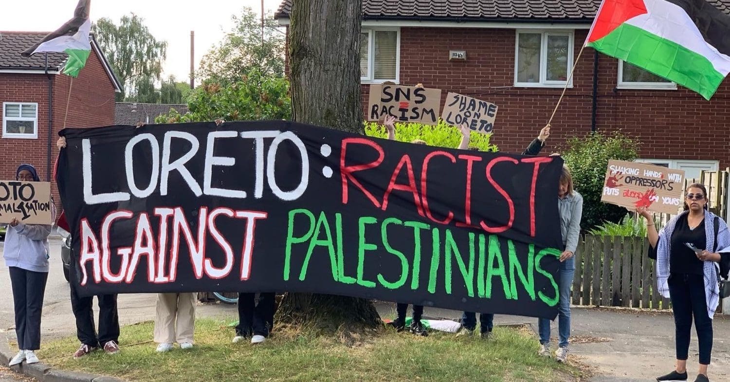 Youth Front for Palestine hold a banner during a demonstration against Loreto High School's hosting of Solutions Not Sides