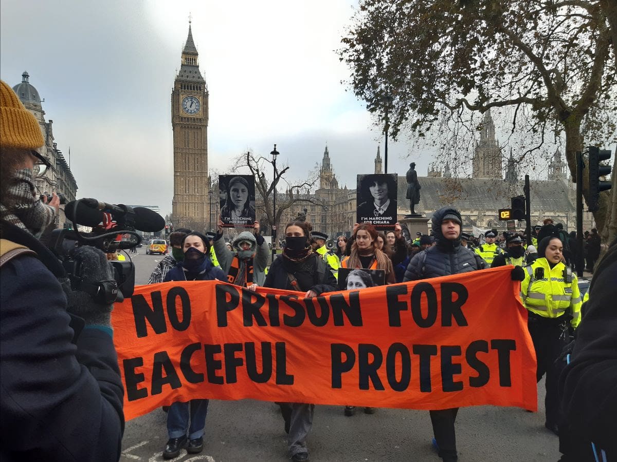 Just Stop Oil marching with parliament in the background