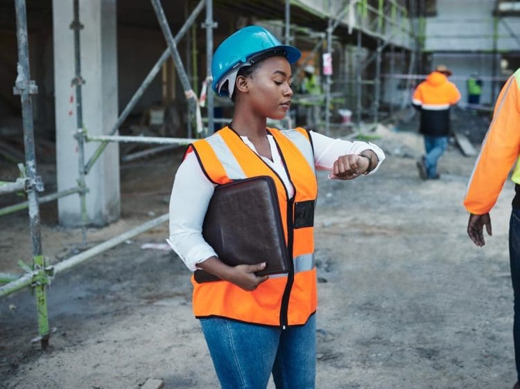 woman looking at her watch women's pay day