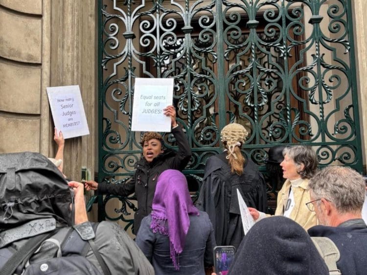 Garrick Club with people protesting outside