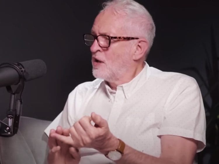 Jeremy Corbyn in front of a mic counting with his fingers 5 demands Peace and Justice Project Labour