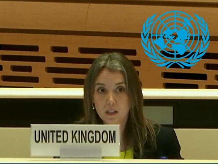 The UK representative of the government giving evidence at a UNCRPD hearing with the UN logo above her