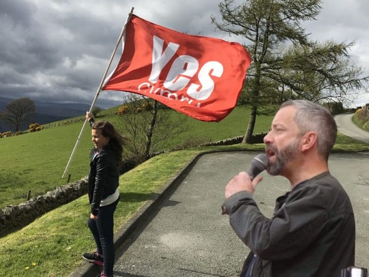 A girl holding a YesCymru flag and its new chair Phyl Griffiths Wales