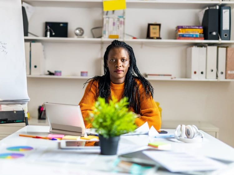 working class women pay a woman sitting at a desk