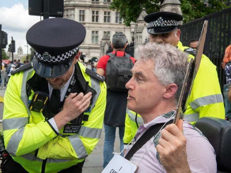 Neil Goodwin with two cops outside parliament