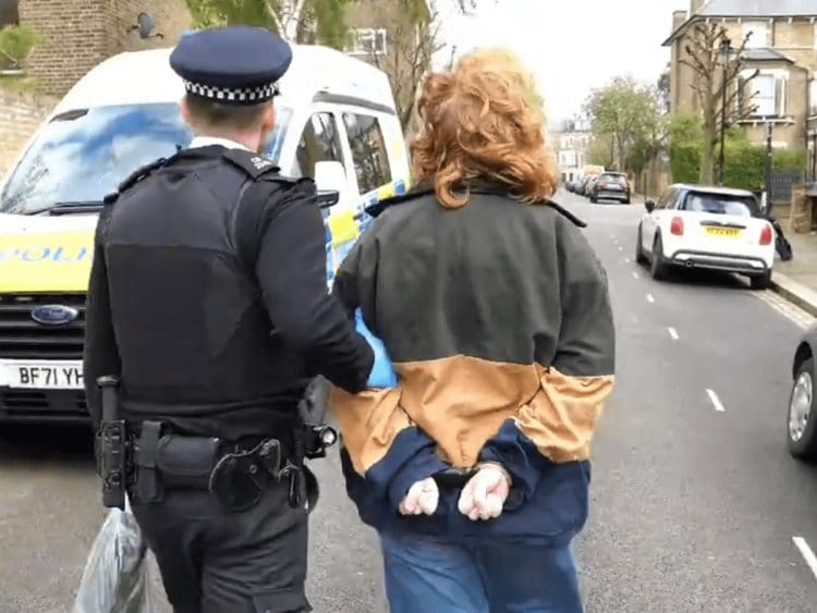 Activist being led away by a cop Starmer