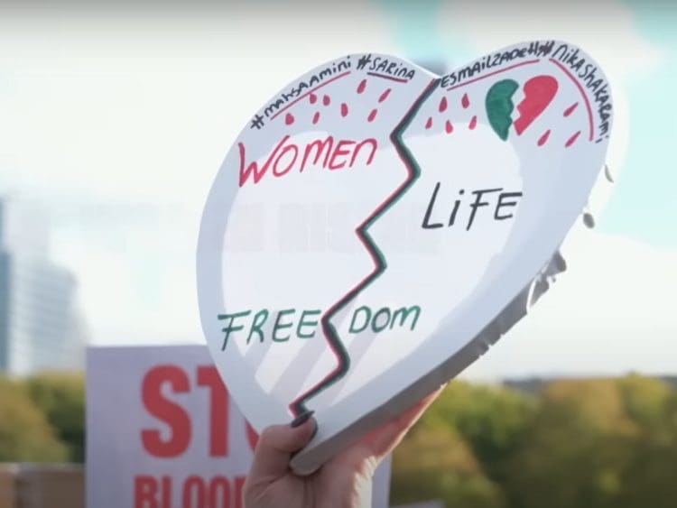 Heart-shaped placard reads: "Women Life Freedom". Iran's executions Iran