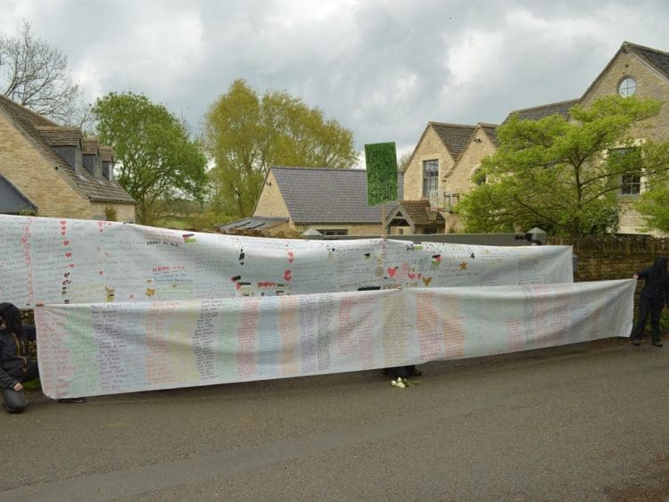 Naming the Dead banners outside David Cameron's private gates Israel