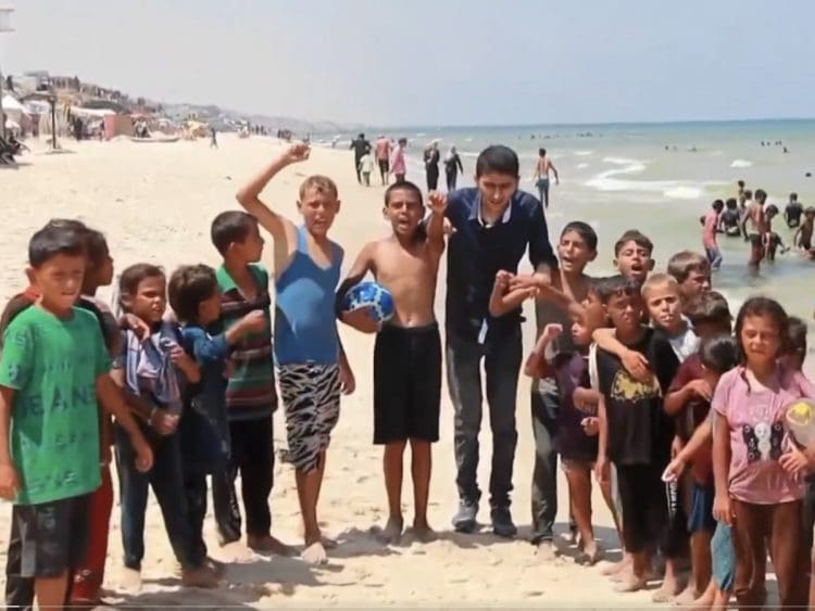 Abubaker Abed with Palestinian children playing football