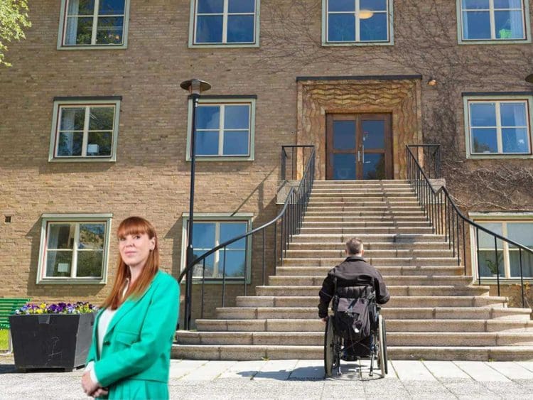 Labour housing policy a male wheelchair user at the bottom of a flight of outside steps leading up to a block of flats with Angela Rayner in a turquoise suit looking at the camera