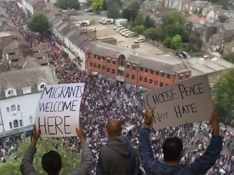 Crowds of antifascists in Walthamstow. Protesters holding up placards that read: "Migrants welcome here" and "Choose peace not hate" race riots