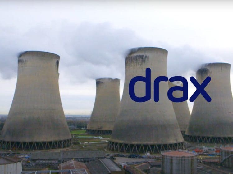 Drax power station pouring out pollution, with the Drax logo.