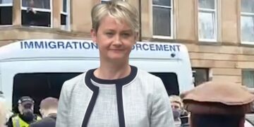 Protesters block an immigration enforcement van. A smiling home secretary Yvette Cooper Labour