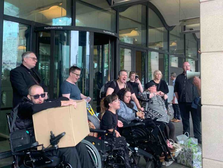 Disabled people protesting outside Portcullis House over the DWP