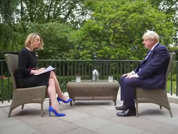 Laura Kuenssberg sat on a garden terrace interviewing Boris Johnson.