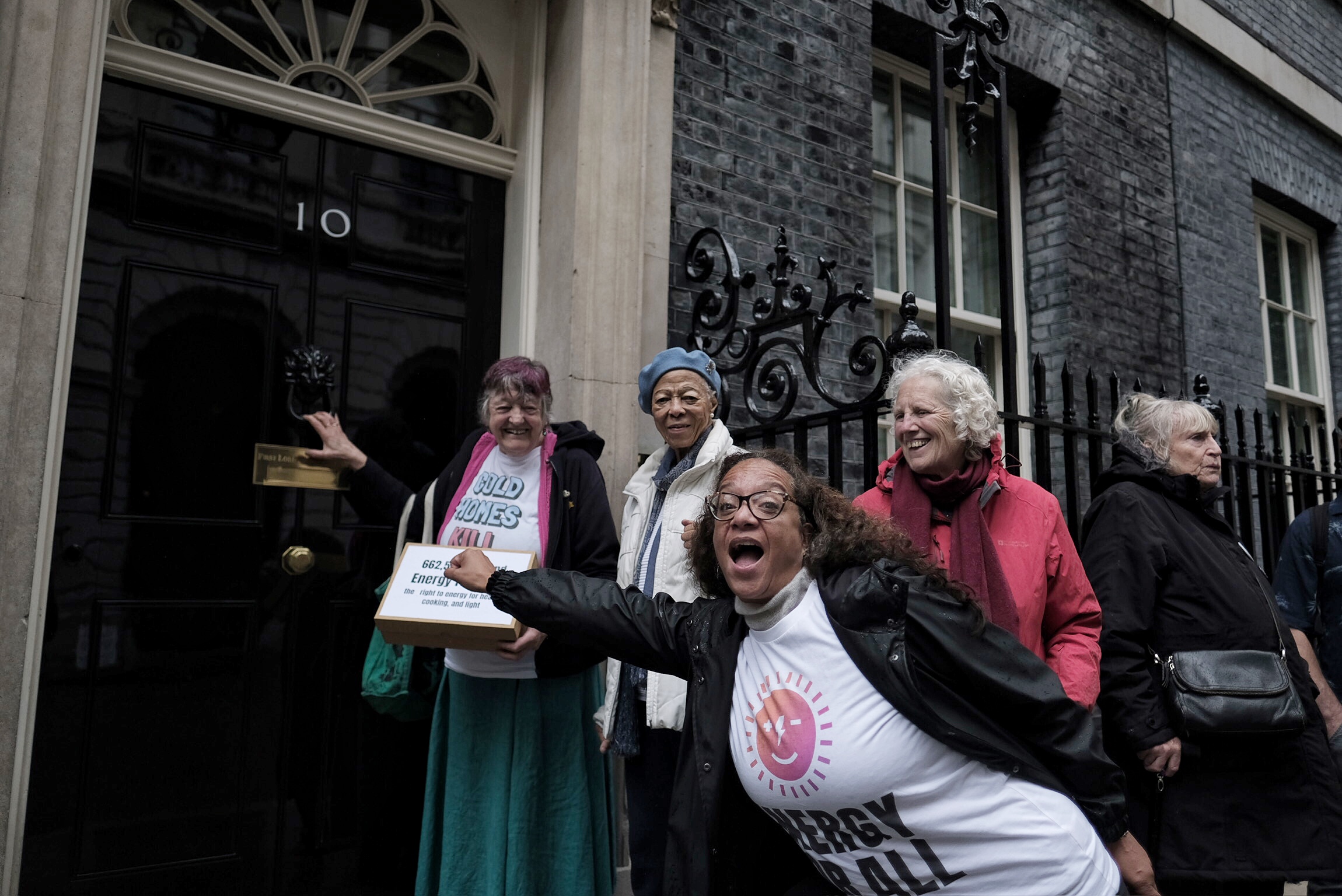 Group of campaigners preparing to knock the front door at Number 10 Downing Street. 