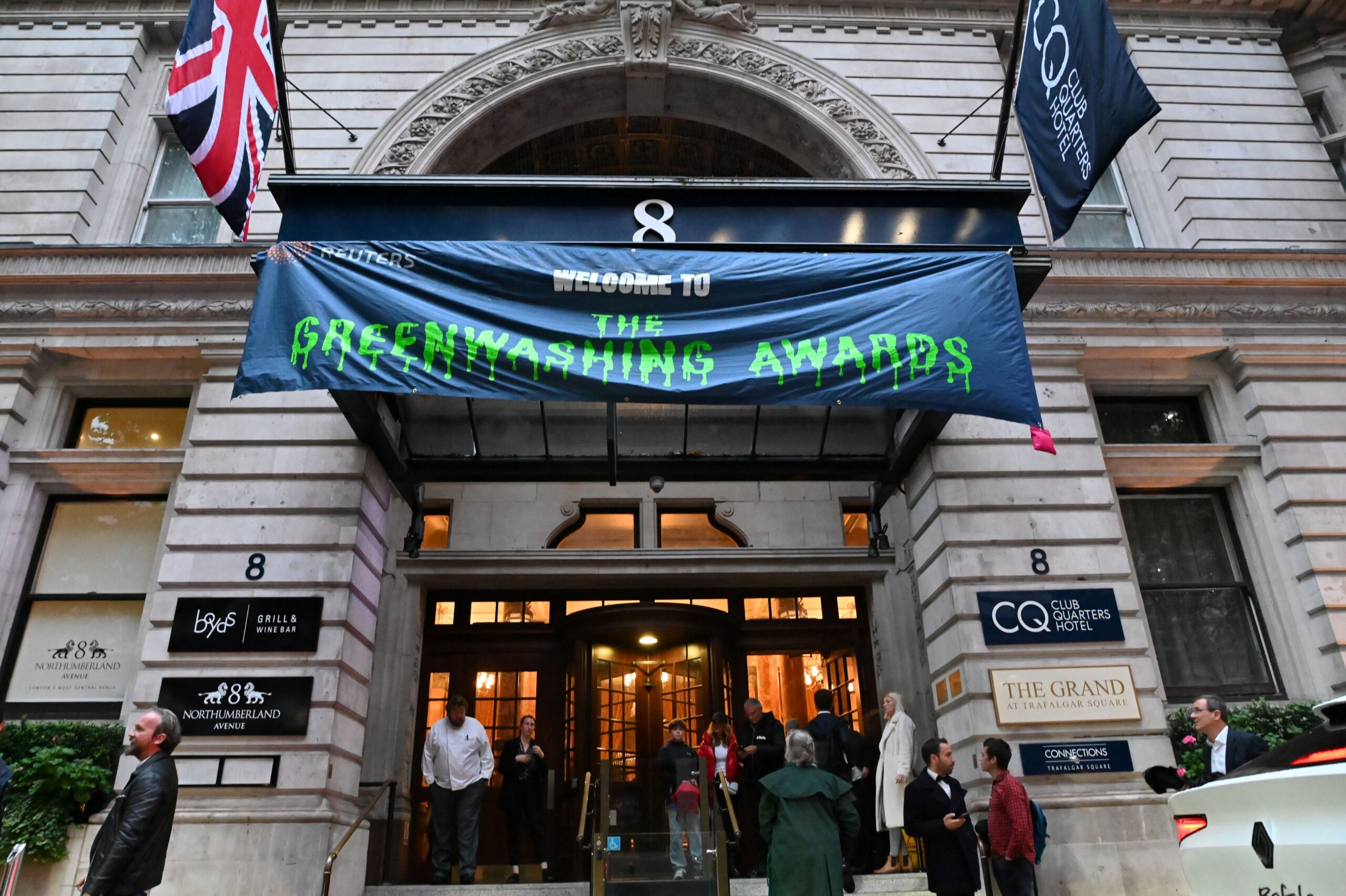 Banner hanging over entrance that reads: "Welcome to the Greenwashing Awards" in green dripping font.  Reuters Sustainability Awards 