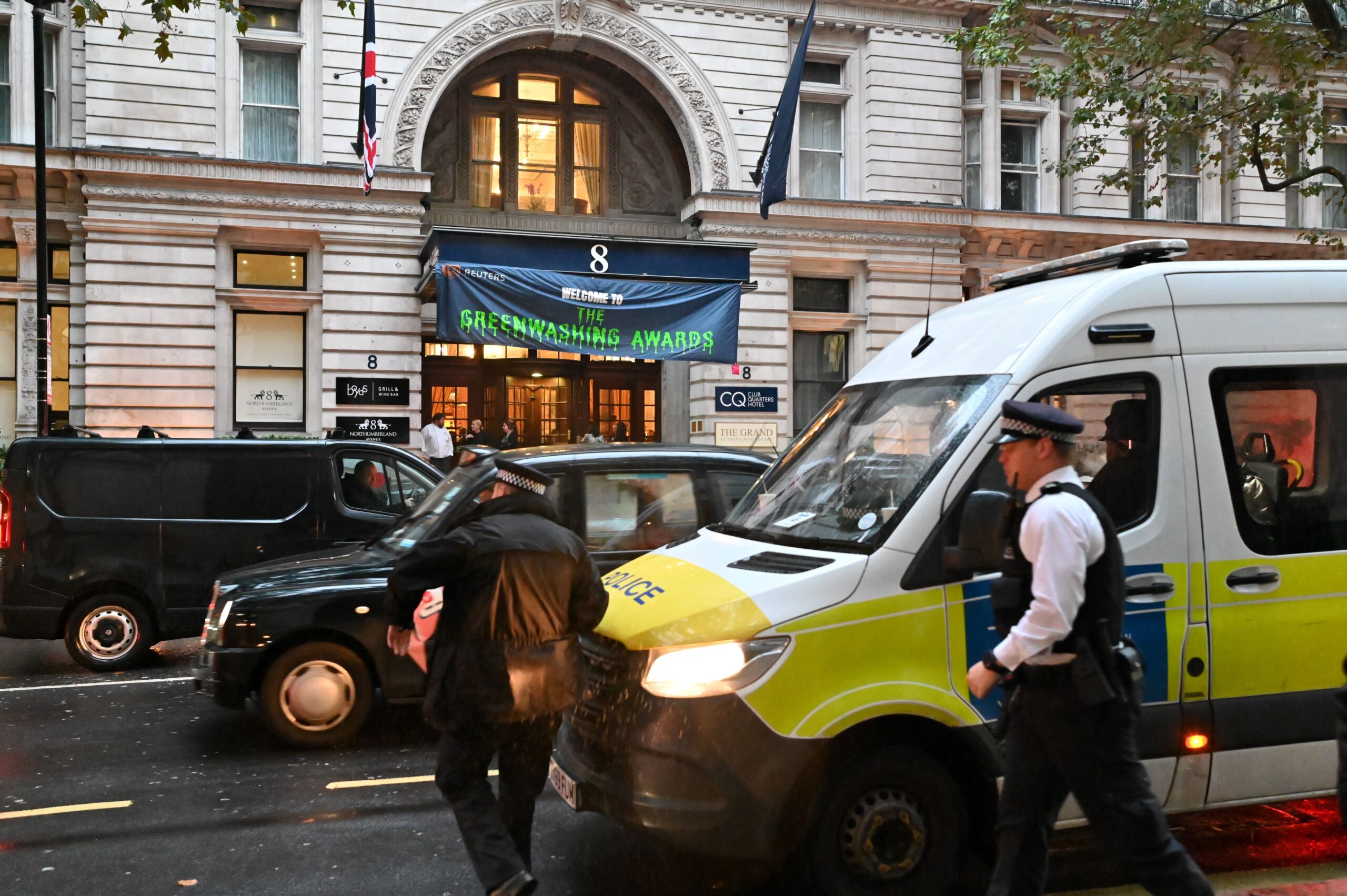 Police van outside the event with two cops heading to the doors. 