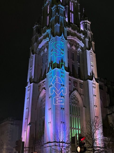 Word art projection with the word "Shame" dripping down Wills Memorial Tower. 